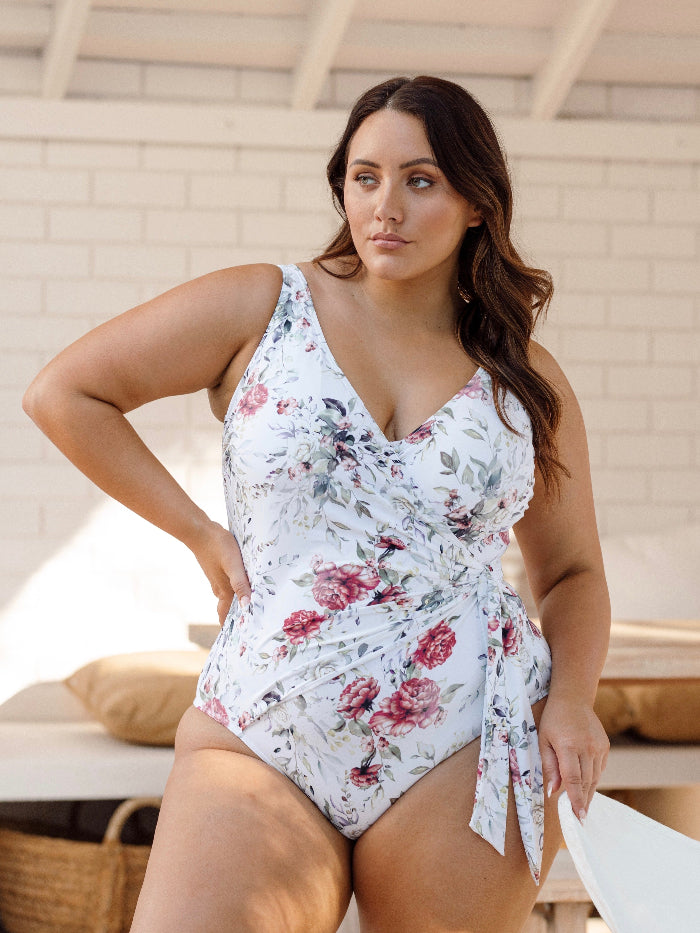 A stylish traveler from New York City is enjoying a luxury resort stay in Maldives wearing the Clementine White Hayes supportive plus size underwire swimsuit by Artesands, known for its high quality tummy control, designer shaping structure, superior breast lift for sagging breasts, and premium luxury curvy fit. She bought it from Sun Vixen Swimwear she wanted a high end elegant one piece bathing suit that looks elegant for tropical trips. Women across Vancouver, Calgary, Dallas, Toronto shop from boutique