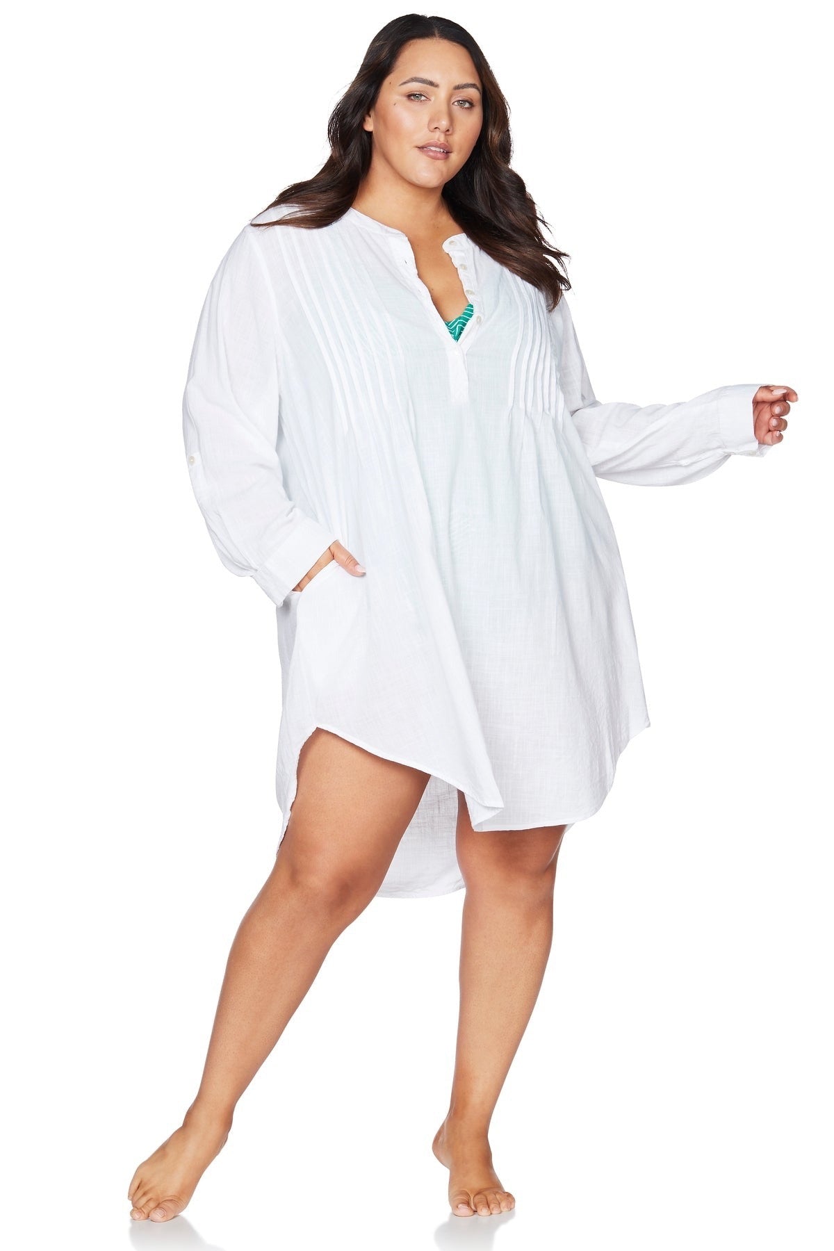 A woman from Los Angeles is enjoying a luxury oceanfront stay in Bora Bora wearing the Artesands white Gershwin long sleeve over shirt beach cover up, one of the most trending swimwear for luxury beach cover ups, sexiest white long sleeve beach shirts, designer vacation cover ups for curvy women, high quality resort wear, best bikini cover ups for tropical travel, and popular high end beachwear USA Canada. She bought it from Sun Vixen Swimwear because she wanted elevated, classy, sexy white beach cover up 