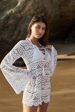edgy elegant exotic expensive White Lace Cover Up PQ Swim Noah Tunic beautiful best quality boutique classy daring designer bathing suits. an elegant lady is wearing a classy see though white beach cover up on her resort vacation to cancun mexico. She looks glamorous and high end wearing her good quality swimsuit that she purchased online from sun vixen swimwear the best retail swimwear store in USA & Canada for men and women who love to travel and look stylish wearing their top quality luxe bathing suits  